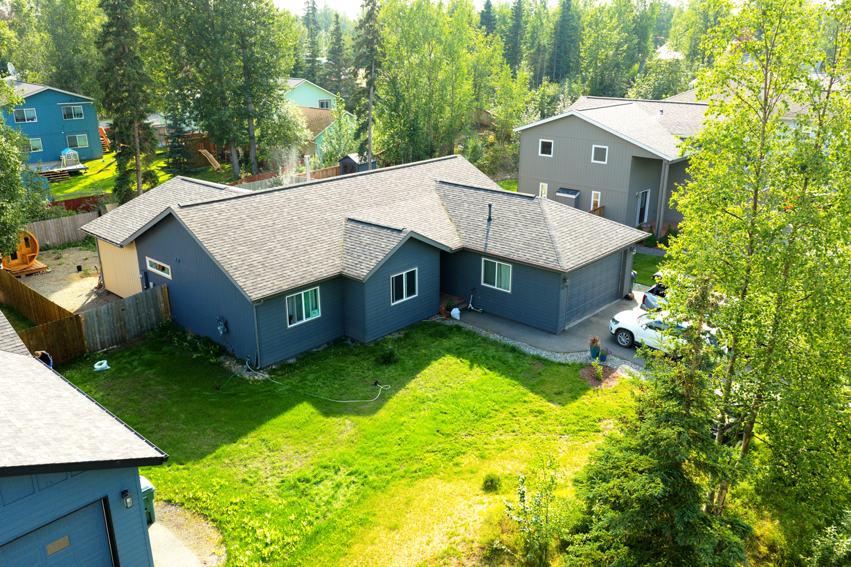Mid-height aerial drone corner photo of an Alaska home